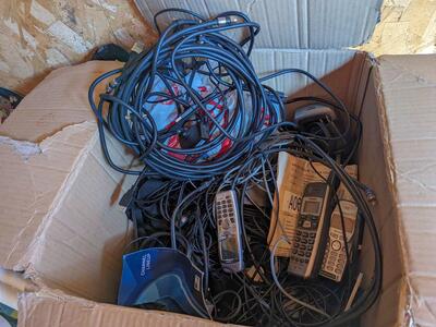 Box of cords and old phones