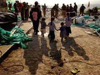 A Jewish settler and her five children walk out of the Jewish settlement of Sanur, in the northern West Bank, Tuesday, Aug. 23, 2005. Thousands of troops pushed into two northern West Bank settlements, Homesh and Sanur, Tuesday and began clearing out hundreds of extremists holed up inside, in the last phase of Israel's dismantling of 21 settlements in the Gaza Strip and four in the West Bank.