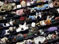 Some of the thousands of displaced residents take cover from Hurricane Katrina at the Superdome, a last-resort shelter, in New Orleans about midnight, Sunday, Aug. 28, 2005. Officials called for a mandatory evacuation of the city, but many residents remained in the city.