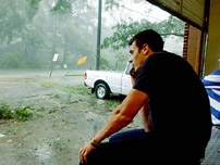 St. Tammany Parish District 3 Fire Station firefighters Danny Flynn, foreground, and Dana Hall watch from the Lacombe, La. station as the winds from Hurricane Katrina reach a peak on Monday Aug. 29, 2005.