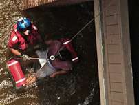 This photo provided Wednesday by the United State Coast Guard shows Petty Officer 2nd Class Scott D. Rady, 34, of Tampa, Fla., helping rescue a pregnant woman from her flooded New Orleans home Tuesday, Aug. 30, 2005. Rady is a rescue swimmer sent from Clearwater, Fla., to help aid in search and rescue efforts in the wake of Hurricane Katrina.