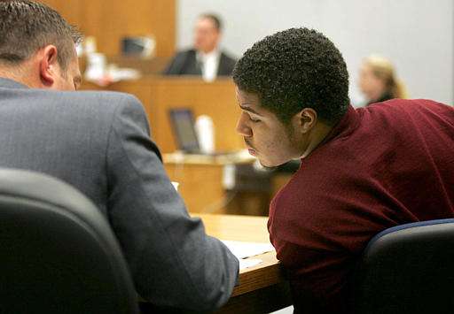 B.J. Mathis, right, leans over to see what his attorney Jere Reneer is writing during the trial in Provo, Utah, Wednesday, Aug. 31, 2005. (AP Photo/Stuart Johnson, Pool)