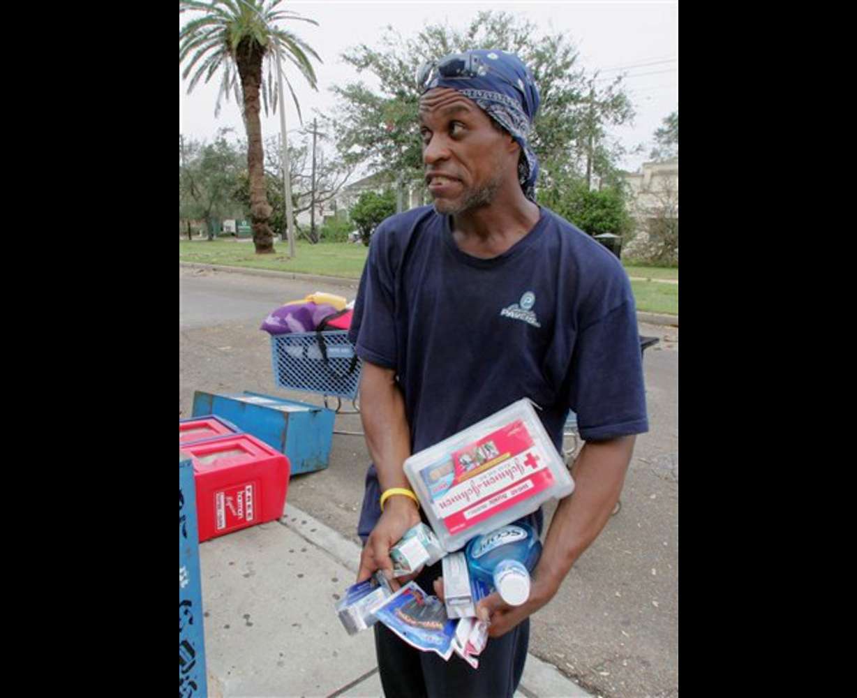 Earl Banks holds armfuls of hygiene products he took from the shelves of a pharmacy in New Orleans on Thursday, Sept. 1, 2005. Area residents have been looting the store since Wednesday, many explaining that they have no other way to get necessities in the aftermath of Hurricane Katrina. (AP Photo/Dave Martin)