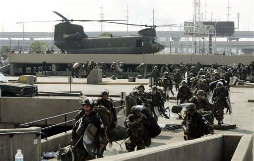 Troops disembark from a military helicopter at the Louisiana Superdome in New Orleans on Friday, Sept. 2, 2005. A huge military presence has arrived in the city, restoring order and bringing with them food and water to feed the thousands of victims of Hurricane Katrina. (AP Photo/Bill Haber)