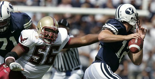 Boston College defensive tackle Al Washington (56) tries to grab hold of BYU quarterback John Beck (12) during the first quarter Saturday, Sept. 3, 2005, in Provo, Utah. Beck got away, but threw an incomplete pass. (AP Photo/Douglas C. Pizac)