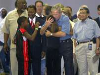 President Bush hugs a little girl at the Bethany World Prayer Center that is now a make shift shelter for victims of Hurricane Katrina, Monday, Sept. 5, 2005, in Baton Rouge, La.