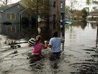 A couple holds hands as they make their way through water filled streets, in Jefferson Parish, La., Monday, Sept. 5, 2005. Residents of the parish are being allowed by authorities to return to their homes for a three day period beginning Monday to record damage and retrieve belongings for the first time since evacuating before Hurricane Katrina hit.