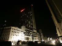 Media trucks line Canal Street in New Orleans Tuesday Sept. 6, 2005. Power has been restored to some hotels in the evacuated city.