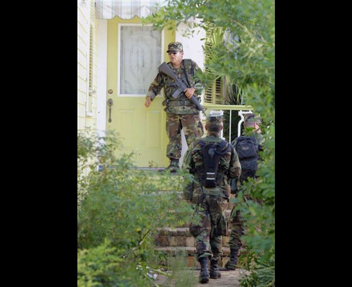 Soldiers patrol a residential section of New Orleans on Wednesday, Sept. 7, 2005. New Orleans officials have said they would begin for forcibly evacuate residents remaining in New Orleans. (AP Photo/Rick Bowmer)