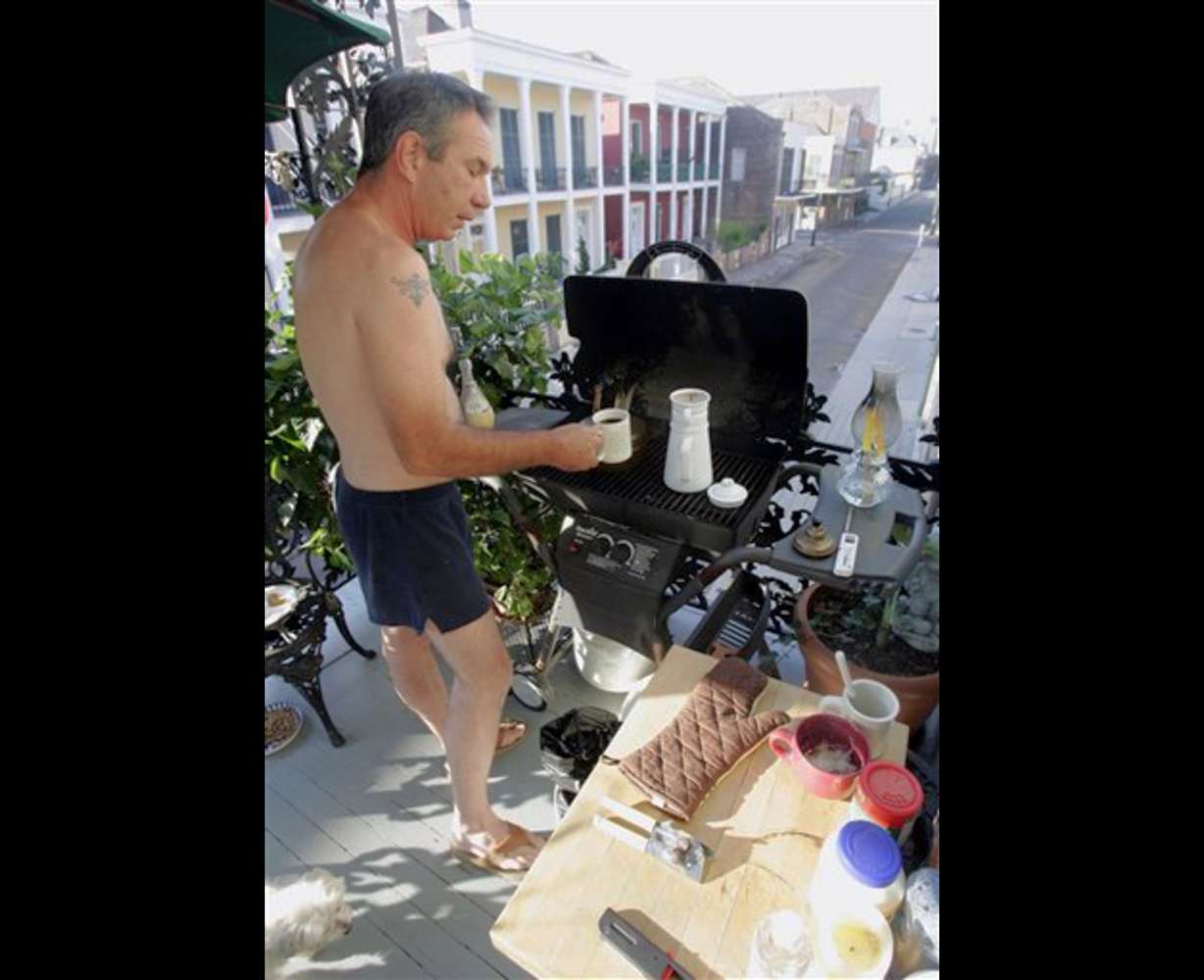 Jack Jones fixes coffee on his balcony in the historic French Quarter in New Orleans on Wednesday, Sept. 7, 2005. New Orleans officials have said they would begin to forcibly evacuate residents remaining in New Orleans. (AP Photo/Eric Gay)