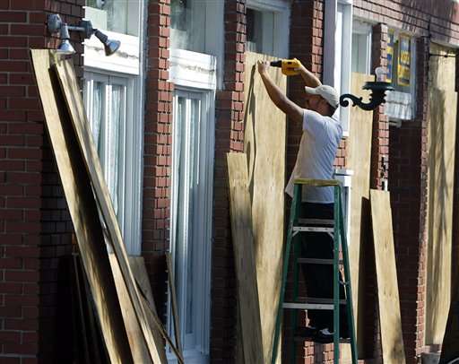 A worker boards up windows on a store in Key West, Fla. Monday, Sept. 19, 2005 as Tropical Storm Rita approaches the area. (AP Photo/J. Pat Carter)