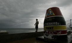 After losing electricity in his home, Dan McCormick came to the Southernmost Point marker in Key West, Fla. Tuesday, Sept. 20, 2005 to look at the ocean before Hurricane Rita hits the area.