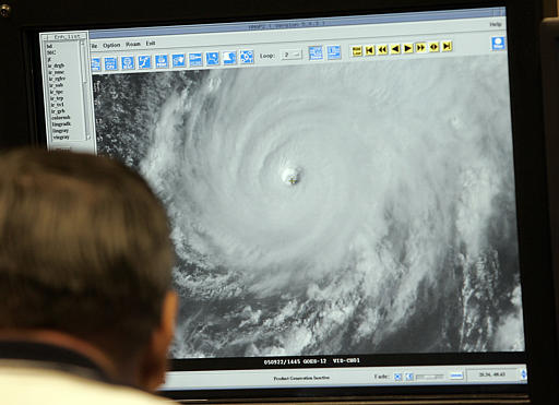 Wally Barnes, lead forecaster, looks at a satellite image of Hurricane Rita Thursday, Sept. 22, 2005 at the National Hurricane Center in Miami. The Category 5 storm weakened slightly Thursday morning, and forecasters said it could lose more steam by the time it comes ashore late Friday or early Saturday. (AP Photo/Alan Diaz)