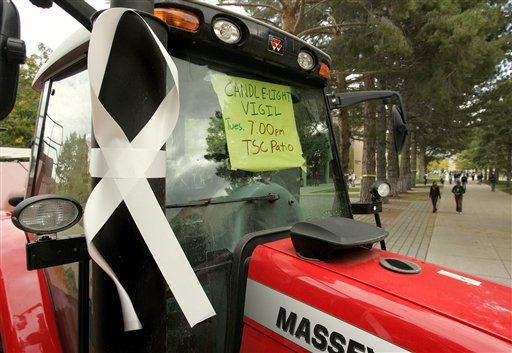 A large white ribbon hangs on the exhaust pipe of tractor on campus Tuesday, Sept. 27, 2005, at Utah State in Logan, Utah. Eight agricultural students and their instructor died in a rollover crash Monday northwest of Tremonton, Utah, while coming back to the college from a field trip. A candlelight vigil is scheduled for Tuesday night. (AP Photo/Douglas C. Pizac)
