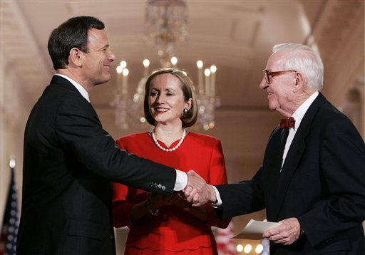 Newly sworn in Chief Justice of the United States, John Roberts is congratulated by Justice John Paul Stevens as Roberts' wife Jane looks on in the East Room of the White House, Thursday, Sept. 29, 2005. (AP Photo/Susan Walsh)
