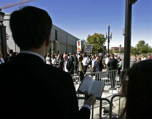 A combination of Mormon University of Utah student choirs sing opposite protesters during the noon break of The Church of Jesus Christ of Latter-day Saints' 175th semi-annual general conference Saturday, Oct. 1, 2005, in Salt Lake City. (AP Photo/Douglas C. Pizac)