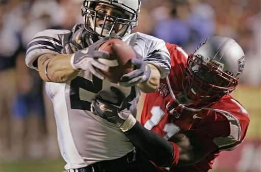 Brigham Young's Jeff Semanoff holds the football out in front of himself and over the goal line as New Mexico's Quincy Black tries to prevent the second quarter touchdown, Saturday, Oct. 8, 2005, in Albuquerque, N.M. (AP Photo/Jake Schoellkopf)