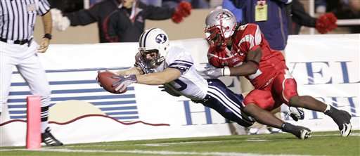 Brigham Young's Matt Allen dives for the end zone as New Mexico's DeAndre Wright tries to stop him in the fourth quarter in Albuquerque, N.M., on Saturday, Oct. 8, 2005. Wright scored on the play as BYU went on to win 27-24. (AP Photo/Jake Schoellkopf)