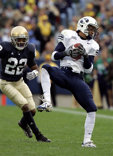 Brigham Young's Todd Watkins makes a catch in front of Notre Dame's Ambrose Wooden for a 17-yard gain during the second quarter in South Bend, Ind., Saturday, Oct. 22, 2005. (AP Photo/Michael Conroy)
