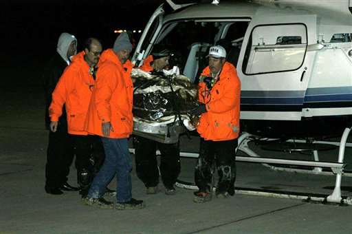 In this image made available by NASA, the Stardust sample return capsule, in a protective covering, is carried out of a helicopter after being transported from its landing site at the U.S. Air Force Utah Test and Training Range early Sunday, Jan. 15, 2006. (AP Photo/NASA, Al Vogel)