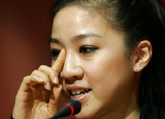 Figure Skater Michelle Kwan of the United States wipes a tear during a press conference in Turin, Italy, Sunday Feb. 12, 2006.