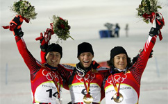 Benjamin Raich of Austria, center, celebrates on the podium ater winning the Men's Slalom as fellow countrymen Reinfried Herbst, left, who took the silver, and Rainer Schoenfelder, bronze, flank him.