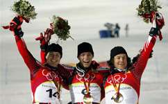 Benjamin Raich of Austria, center, celebrates on the podium ater winning the Men's Slalom as fellow countrymen Reinfried Herbst, left, who took the silver, and Rainer Schoenfelder, bronze, flank him.