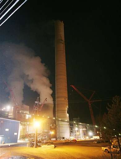 One worker is unaccounted for and three others had to be rescued by helicopter after a fire broke out in this 1,000-foot-tall smokestack under construction at an American Electric Power plant on Saturday, March 4, 2006, near Moundsville, W.Va. The fire occurred at AEP's Kammer-Mitchell plant south of Moundsville, which is about 68 miles southwest of Pittsburgh. (AP Photo/Charles P. Saus)