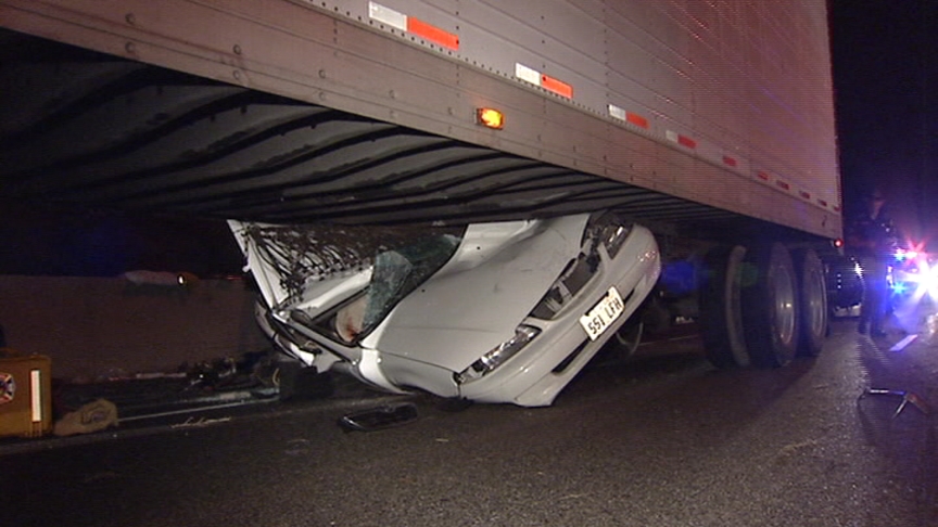 Car Dragged Under Semi, Driver Survives 