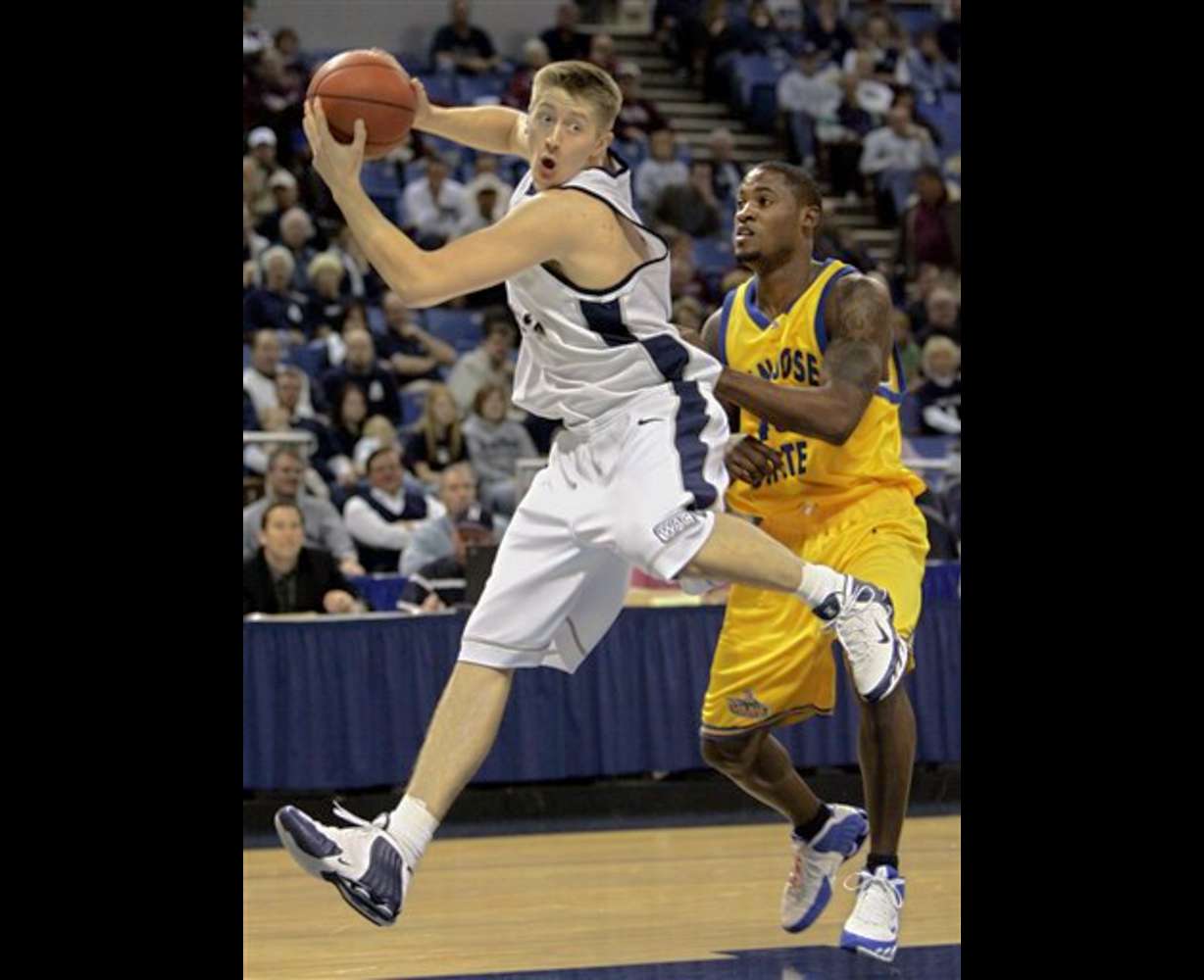 Utah State's Mike Harris, left, pulls down a rebound against San Jose State's Demetrius Brown during the first half of a Western Athletic Conference tournament basketball game in Reno, Nev., Thursday, March 9, 2006. (AP Photo/Rich Pedroncelli)