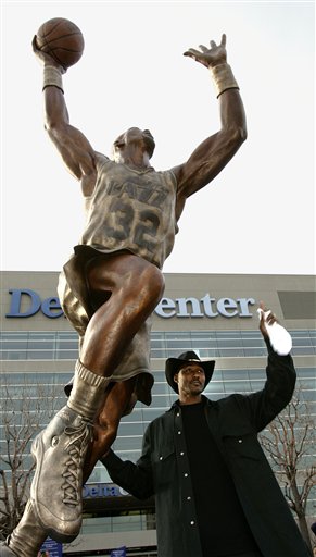 Former Utah Jazz forward Karl Malone poses with his statue prior to the retirement of his basketball jersey Thursday, March 23, 2006, in Salt Lake City. (AP Photo/Douglas C. Pizac)