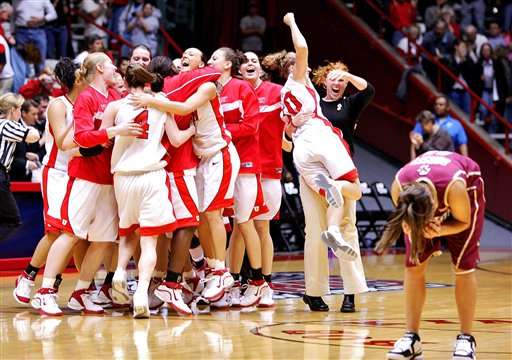 Boston College guard Kindyll Dorsey, far right, hangs her head as the buzzer sounds, while Utah celebrates a 57-54 win in the NCAA basketball tournament regional semifinals Saturday, March 25, 2006 at The Pit in Albuquerque, N.M. (AP Photo/Matt York)