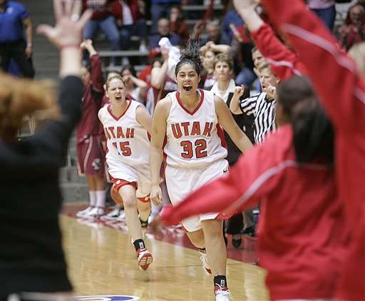 Utah forward Joh-Teena Filipe (32) and Morgan Warburton celebrate Utah's win in the NCAA basketball tournament regional semifinal against Boston College on Saturday, March 25, 2006, at The Pit in Albuquerque, N.M. Utah won 57-54. (AP Photo/Jake Schoellkopf)