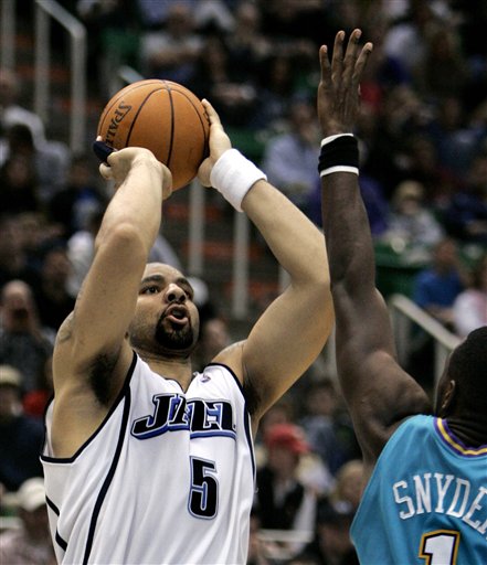 Utah Jazz forward Carlos Boozer (5) shoots against New Orleans guard Kirk Snyder (1) during the fourth quarter of their NBA basketball game Monday, March 27, 2006, in Salt Lake City. Boozer finished the night with 21 points for the game high. The Jazz beat the Hornets, 104-80. (AP Photo/Douglas C. Pizac)