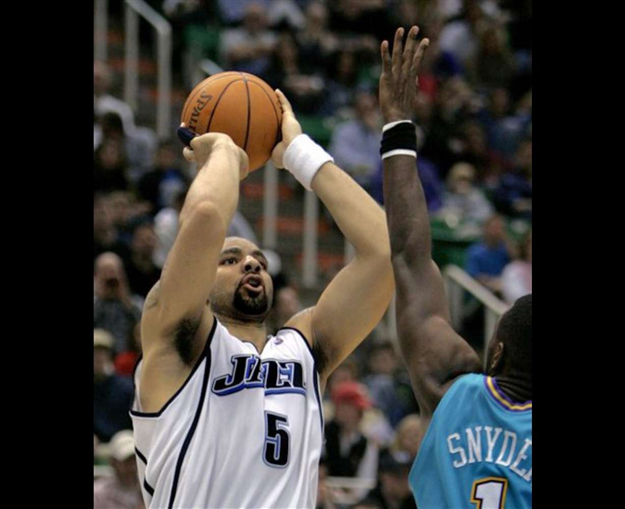 Utah Jazz forward Carlos Boozer (5) shoots against New Orleans guard Kirk Snyder (1) during the fourth quarter of their NBA basketball game Monday, March 27, 2006, in Salt Lake City. Boozer finished the night with 21 points for the game high. The Jazz beat the Hornets, 104-80. (AP Photo/Douglas C. Pizac)