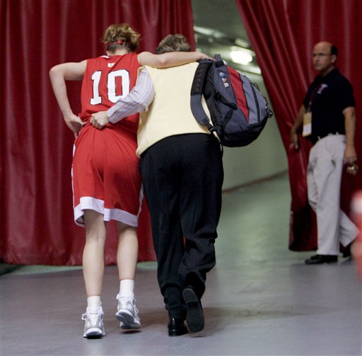 Utah forward Shona Thorburn (10) is helped off the court after being injured during the first half of the NCAA Albuquerque regional championship basketball game against Maryland Monday, March 27, 2006, in Albuquerque, N.M. (AP Photo/Jake Schoellkopf)