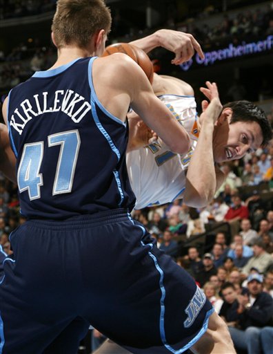 Utah Jazz forward Andrei Kirilenko, front, strips the ball out of the hands of Denver Nuggets forward Eduardo Najera of Mexico in the first quarter of an NBA basketball game in Denver on Wednesday, March 29, 2006. (AP Photo/David Zalubowski)