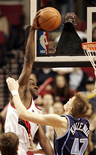 Utah Jazz's Andrei Kirilenko (47), of Russia, attempts to defend as Portland Trail Blazers' Martell Webster dunks in the first quarter of thir NBA basketball game Saturday, April 1, 2006, at the Rose Garden, in Portland, Ore. (AP Photo/Rick Bowmer)