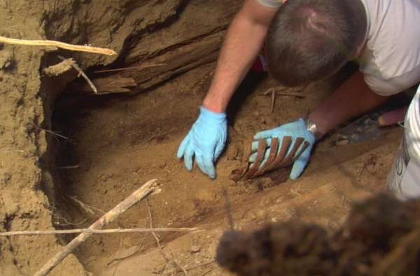 Image from the documentary showing William Long's body being uncovered.