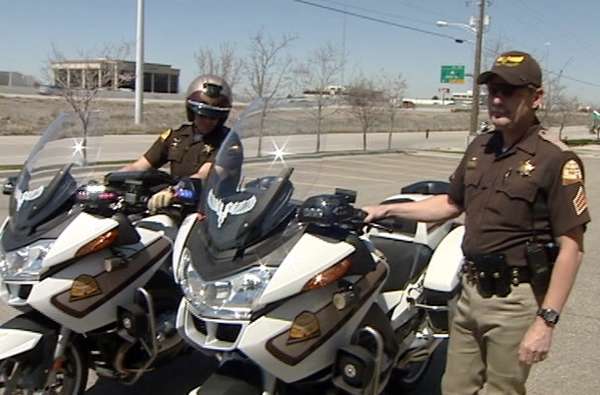 Sgt. Gary Caldwell and a colleague show off two of UHP's new motorcycles