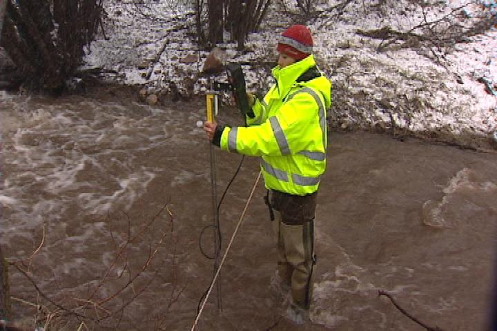 Hydrologist keeping an eye on streams following rainstorm