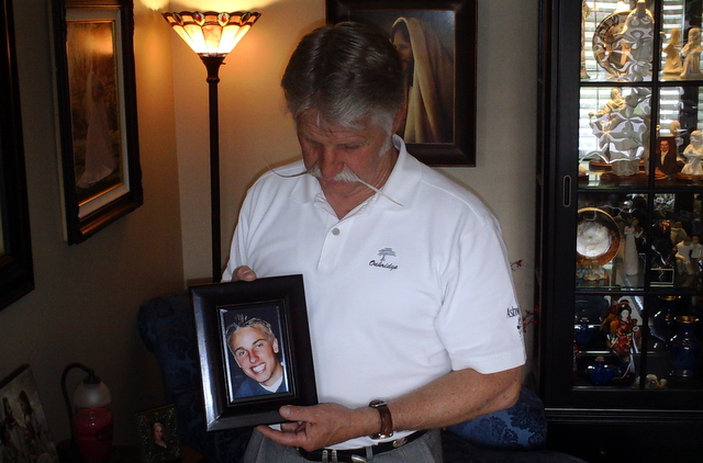 Murray mayor Dan Snarr holding a picture of his son, Denver who died from a prescription drug overdose.