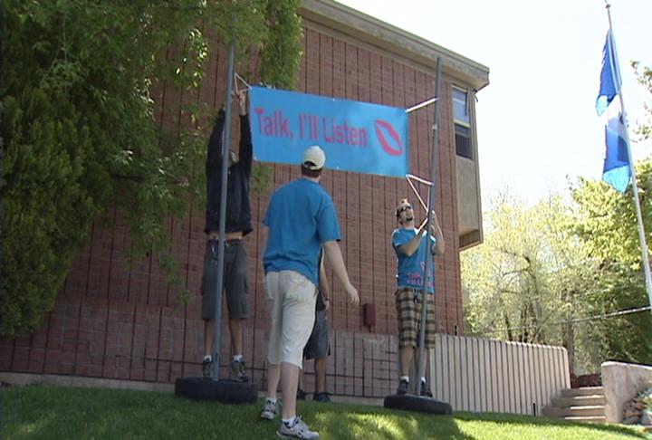 Students post a sign advertising their group "Talk. I'll Listen." They hope fellow students will come to them when they just need someone to talk to.