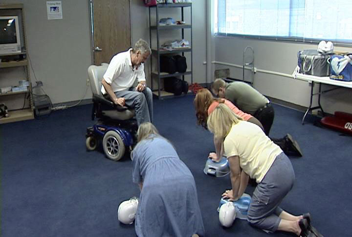 Red Cross volunteer Skip Morgan teaches a class how to perform CPR.