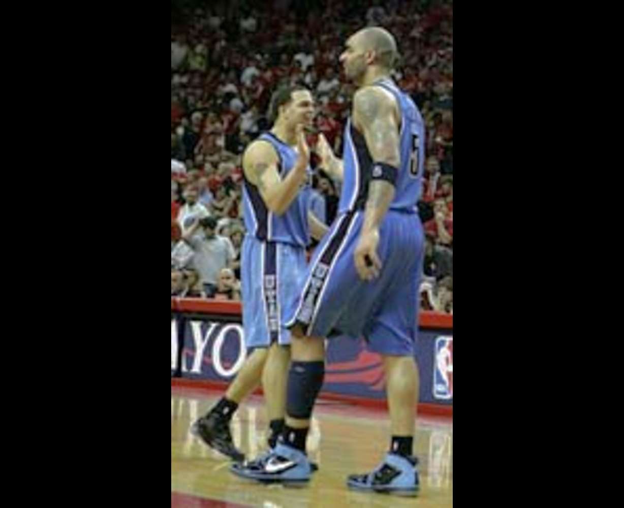 Utah Jazz's Deron Williams, left, and Carlos Boozer celebrate in the final seconds of Game 7.