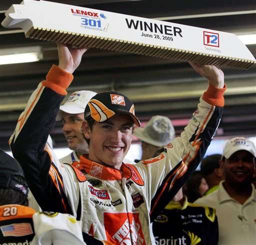 Joey Logano smiles in victory lane after winning the rain-shortened NASCAR Lenox Industrial Tools 301 auto race at New Hampshire Motor Speedway in Loudon, N.H., Sunday, June 28, 2009. (AP Photo/Jim Cole)