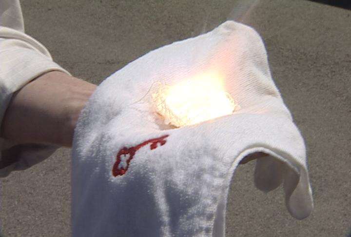Magnesium burns at 5,600 degrees on a towel in KSL's Jed Boal's hand. He isn't burned because the towel was sprayed with Cold Fire.