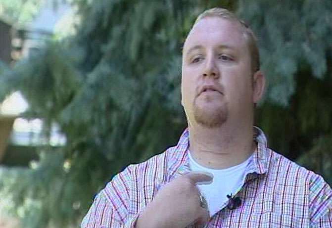 Matt Sevy shows the scar he received when the fishing line he ran into while riding his motorcycle cut his neck.