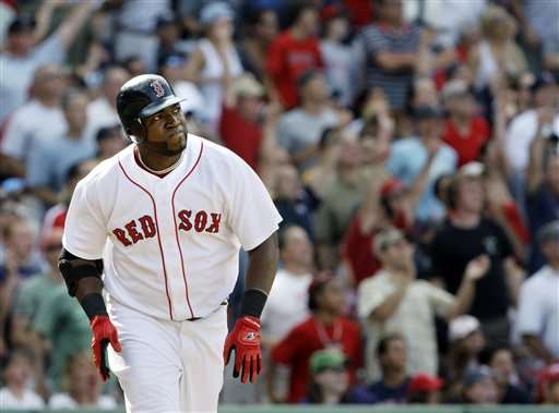 Fans, background, cheer Boston Red Sox's David Ortiz as he runs to first after hitting a three-run home run in the seventh inning against the Oakland Athletics in a baseball game at Fenway Park in Boston, Thursday, July 30, 2009. (AP Photo/Elise Amendola)