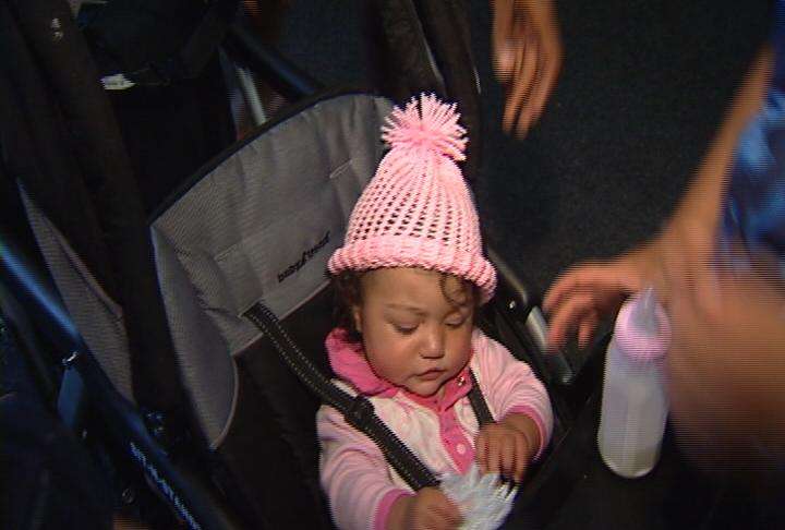 Assisted living center residents make baby caps for homeless